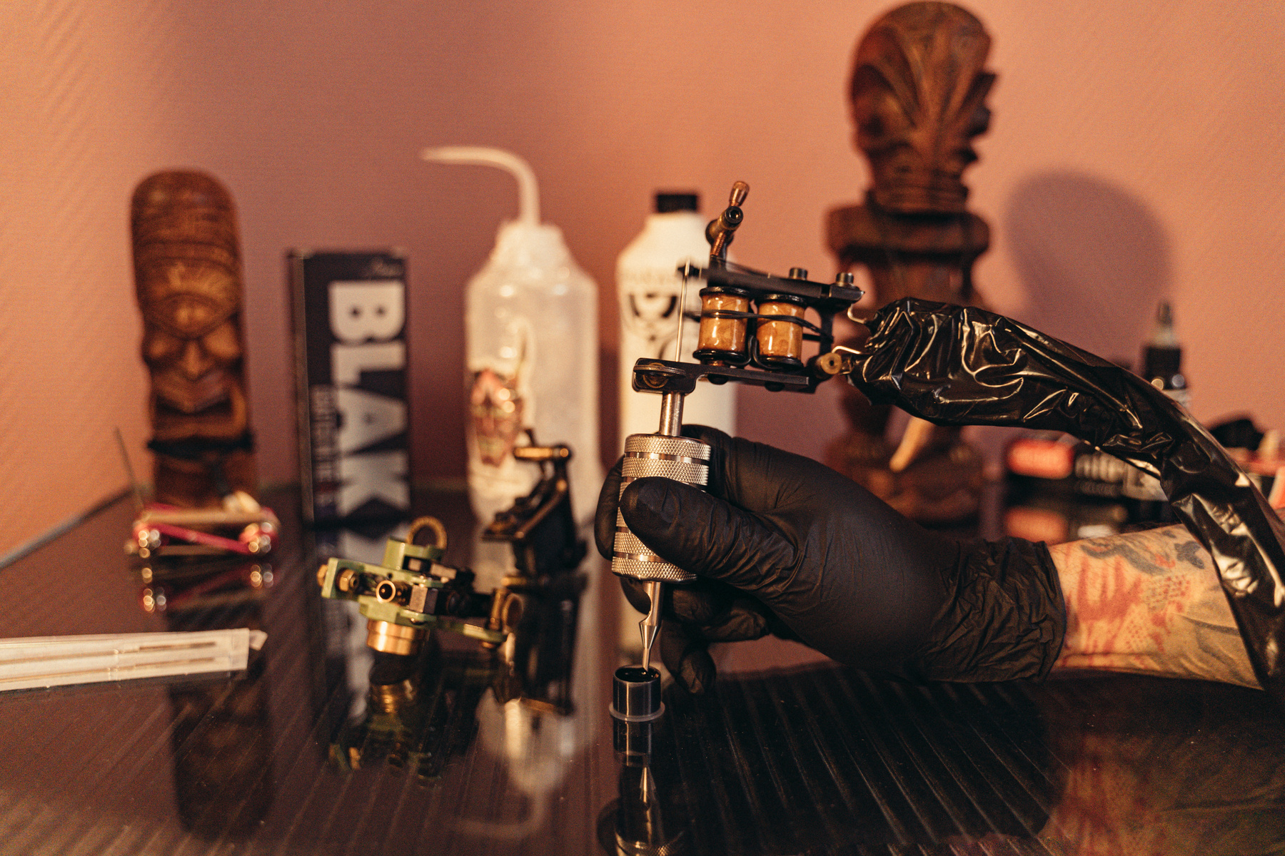 A Person Wearing Gloves Holding Tattoo Machine