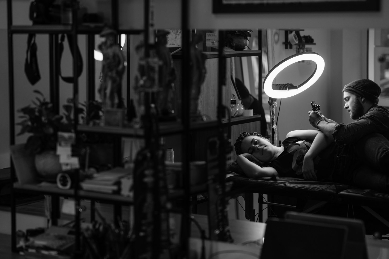 Grayscale Photo of a Tattoo Artist Working on a Client